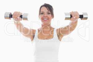 Portrait of young woman exercising with dumbbells