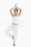 Portrait of woman in sportswear doing the tree pose