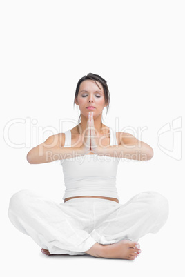 Young woman with crossed legs in praying position