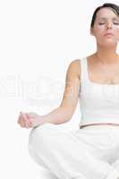 Young woman sitting in lotus position