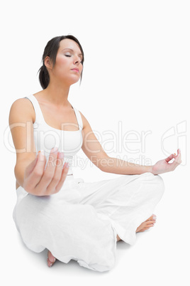 Young woman sitting in lotus position