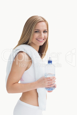 Portrait of smiling young woman with towel around neck holding w