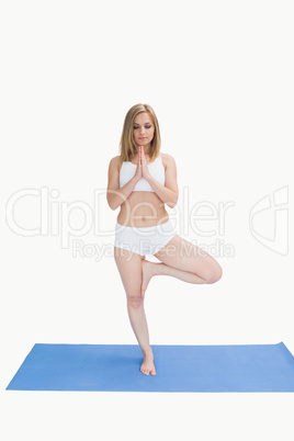 Young woman standing in praying position