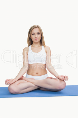 Portrait of young woman sitting in lotus position