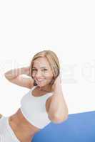 Portrait of happy woman doing sit-ups on exercise mat