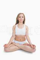 Woman sitting in lotus position with eyes closed