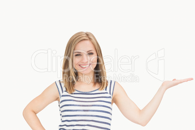 Portrait of casual woman holding out open palm