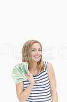 Portrait of happy young woman with fanned dollars