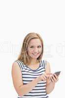 Portrait of casual young woman with smartphone