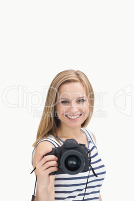 Portrait of happy young female with photographic camera