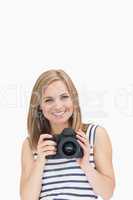 Portrait of happy young female with photographic camera