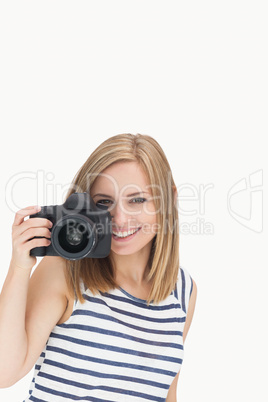 Portrait of happy young female with photographic camera