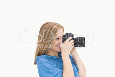 Side view of happy female photographer with photographic camera