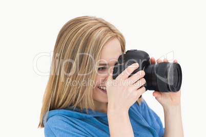 Side view of happy female photographer with photographic camera