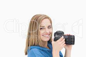 Portrait of happy female photographer with photographic camera