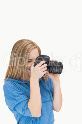 Side view of female photographer with photographic camera