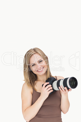 Portrait of happy female with photographic camera