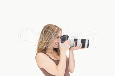 Side view of female photographer with photographic camera