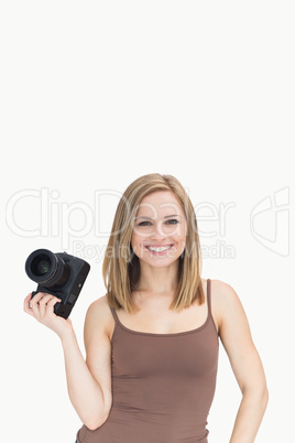 Portrait of happy female with photographic camera