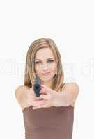 Portrait of casual woman aiming gun towards you