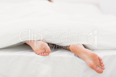 Woman's feet sticking out of blanket