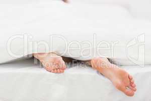 Woman's feet sticking out of blanket