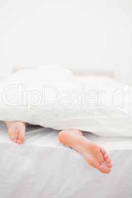 Woman's feet sticking out of blanket