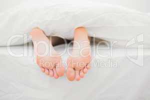 Woman's feet sticking out of blanket