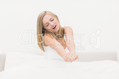 Woman yawning in bed