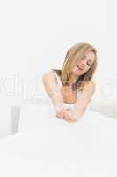 Sleepy woman stretching  in bed