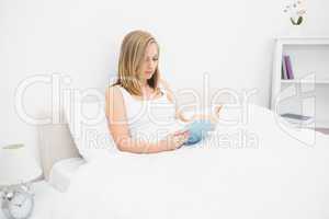 Woman reading book in bed