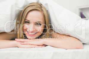 Close-up portrait of beautiful woman in bed