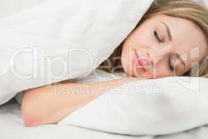 Beautiful woman sleeping with eyes closed in bed