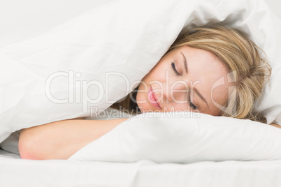 Beautiful young woman sleeping in bed