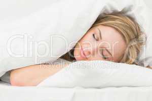 Beautiful young woman sleeping in bed