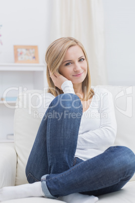 Portrait of relaxed woman sitting on sofa Portrait of relaxed woman sitting on sofa