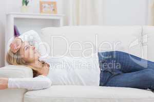 Casual thoughtful woman lying on sofa