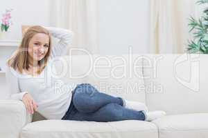 Portrait of casual happy woman sitting on sofa