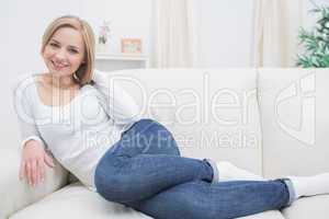 Portrait of casual happy woman sitting on sofa