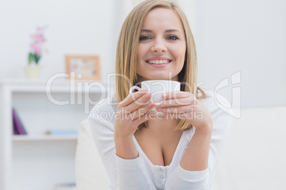 Portrait of woman with tea cup at home