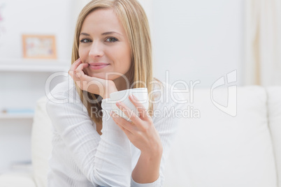 Portrait of woman with tea cup at home