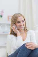 Casual woman using mobile phone at home