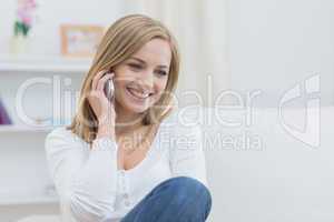 Casual young woman using mobile phone at home