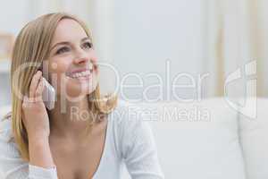 Casual young woman using mobile phone at home