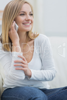 Casual young woman using mobile phone at home