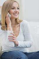 Casual young woman using mobile phone at home