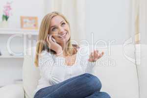 Casual happy woman using cellphone at home