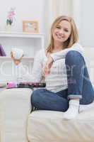 Portrait of young woman with coffee cup at home