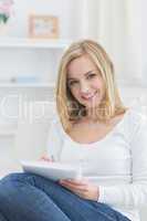 Portrait of happy woman with notepad at home