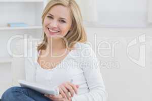 Portrait of happy woman with notepad at home